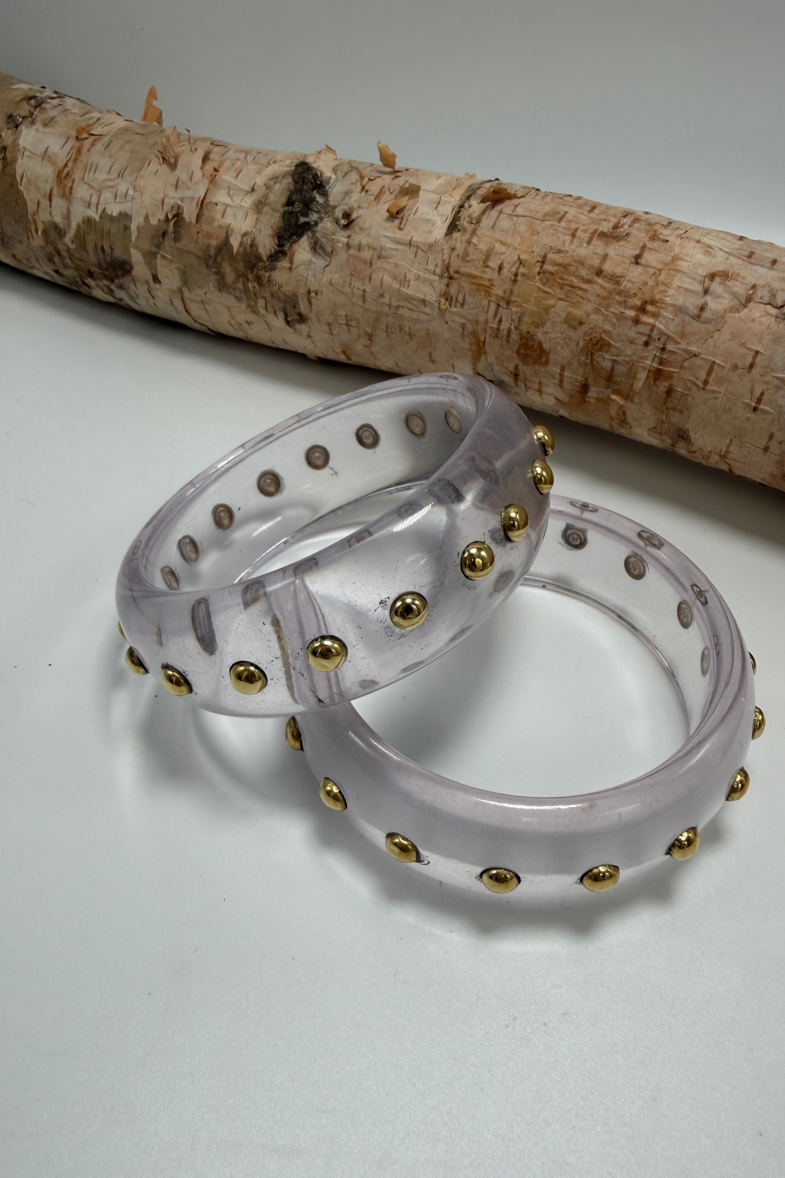 Clear bangle with gold studs